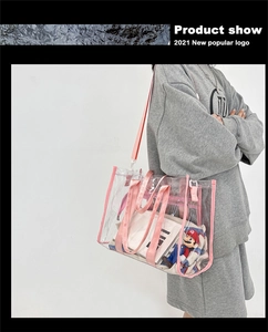 Detail of clear PVC tote bag with pink trim featuring a removable canvas inner pouch