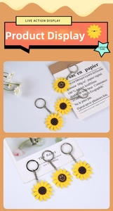 Detailed close-up of sunflower PVC keychains with smiling faces and silver metal rings