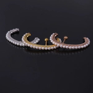 Three C-shaped pearl earrings in silver, gold, and rose gold finish on black background