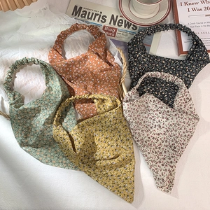 Flat lay of floral triangular headbands in five colors with vintage aesthetic props