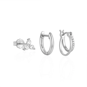 Detail of S925 sterling silver earring set featuring clear gems and polished metal hoops