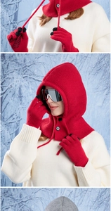 Macro shot of thick red knit winter hood with drawstring and conductive touch gloves