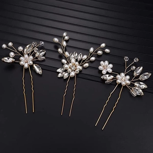 Detailed view of 3-piece gold bridal hair pin set with white pearls and clear crystals