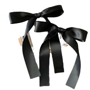 Set of two elegant black satin bow hair clips for women in a minimalist ballet style