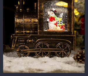 Close-up of vintage bronze Christmas train snow globe with snowman and glitter