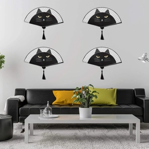 Detail of four Japanese folding fans featuring cartoon black cat faces and black tassels