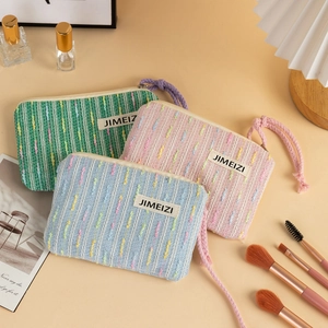 Three-piece textured woven makeup bags in pastel colors with polka dots and zip closure