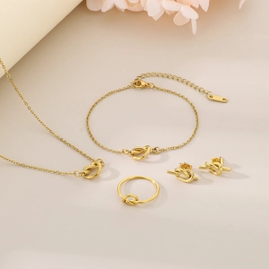 Golden stainless steel knot jewelry set with necklace, bracelet, earrings and ring