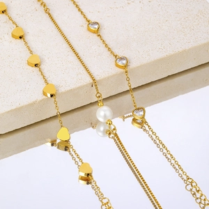 Elegant 18k gold plated stainless steel bracelets with heart charms and pearl detail