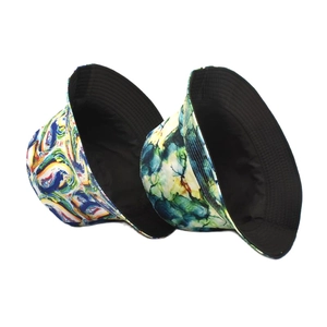 Reversible bucket hat featuring colorful abstract art print and solid black inner lining