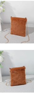 Detail of a brown faux fur mini square bag with elegant golden chain strap