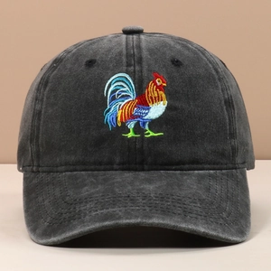 Detailed view of colorful rooster embroidery on washed black cotton baseball cap