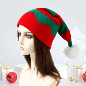 Knitted Christmas elf hat in red and green stripes with a white pompom on a head model