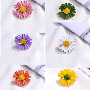 Set of colorful enamel daisy brooches in pink, green, purple, white, orange, and yellow