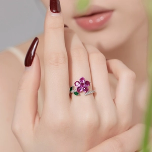 Detail of S925 silver ring featuring a floral design with pink and green zircon stones