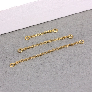 Detailed view of three gold S925 sterling silver geometric tassel chains for jewelry making