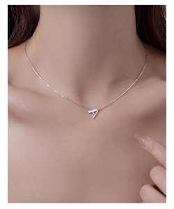 Detail of silver letter A necklace pendant with sparkling crystals on a fine chain