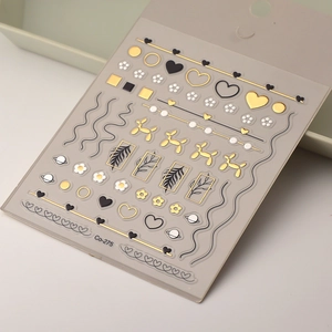 Detailed 5D embossed nail stickers featuring gold balloon dog and heart patterns