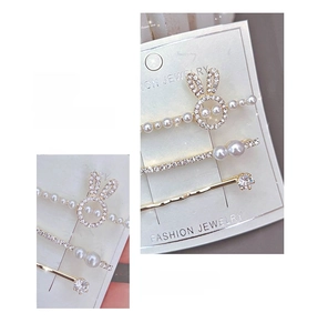 Detailed view of three-piece rabbit hair clip set with pearls and rhinestones