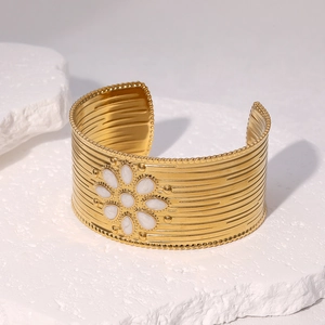 Gold plated stainless steel open bangle with bohemian white sun petal motif on stone base