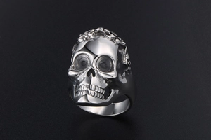 Macro shot of silver skull ring showing detailed metal texture and rock punk style