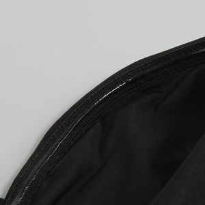 Detailed close-up of non-slip silicone strip on black sequin halter dress hemline
