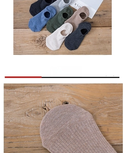 Detail view of cotton invisible low-cut socks in six vintage colors on a wood surface