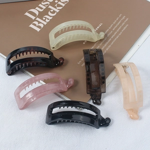 Minimalist glossy acrylic banana hair clips in multi-color set on stylish magazine