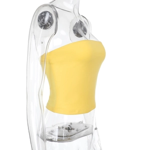 Side view of yellow strapless crop top on a clear mannequin with a clean white background