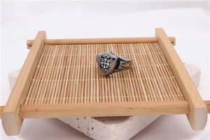 Macro detail of retro shield ring with cross engraving and vintage carved textures