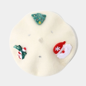 Detail view of a cream wool beret featuring festive Christmas tree and Santa appliques