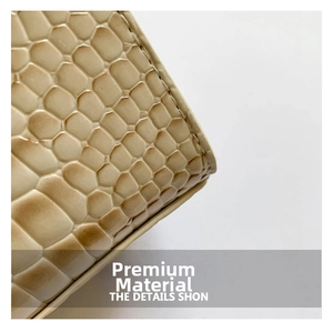 Close-up of premium beige crocodile pattern leather with precise stitching detail