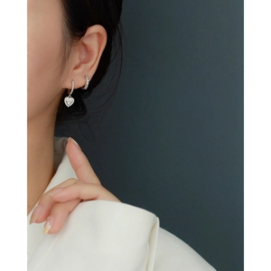 Detailed close-up of S925 sterling silver heart earrings with micro-pave cubic zirconia