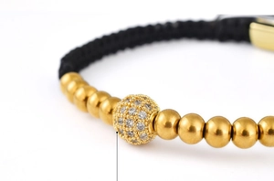 Macro detail of 5mm gold copper beads and micro-paved zircon ball on braided bracelet