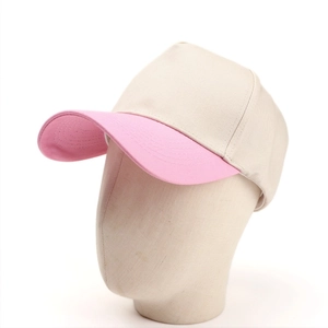 Detail view of a 5-panel trucker hat in beige and pink on a professional mannequin head