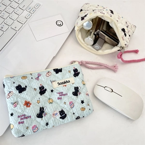 Close-up of quilted floral cosmetic bags with cute cat prints and pink rope zippers
