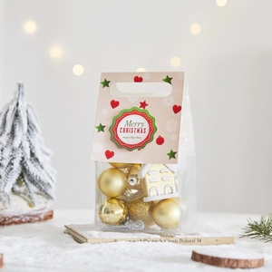 Golden Christmas ball ornaments and house pendant in a festive gift bag with handle