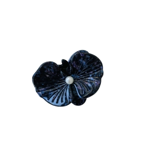 Elegant purple marble orchid hair claw clip with a central pearl on a white background