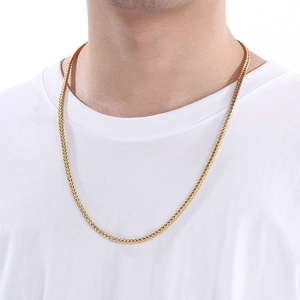 Detailed view of a gold woven Chopin chain necklace worn by a model for a stylish look
