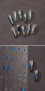 Macro view of blue butterfly and silver moon nail art stickers with vintage gemstone details