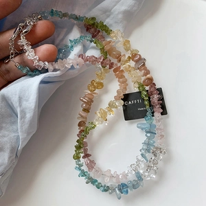 Detail of colorful multi-layer natural stone bead necklace with silver lobster clasp