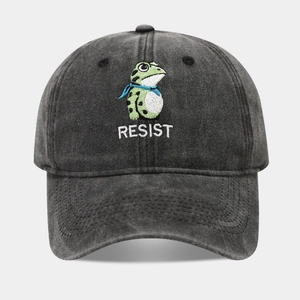 Close-up of green frog embroidery and RESIST text on washed cotton baseball cap
