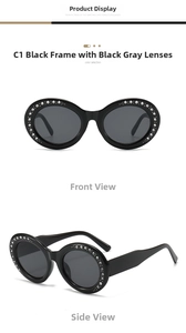 Detail of black oval sunglasses with rhinestone-encrusted frames and dark lenses