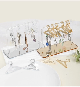Acrylic earring display stand with mini clothes hangers and mirror base in amber and clear