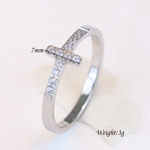 Macro shot of 7mm stainless steel ring showing cross design with inset zircon details