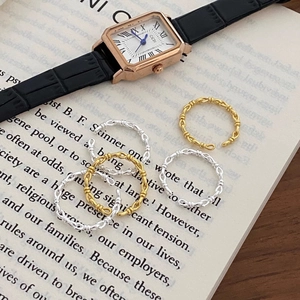 Detail of woven chain link rings in gold and silver finish on a vintage book