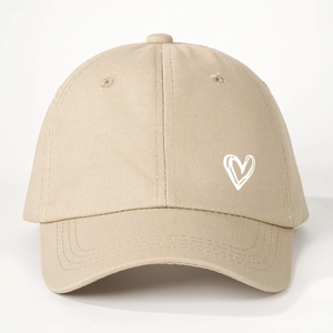 Close-up of beige cotton baseball cap featuring embroidered white heart outline