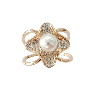 Elegant gold flower ring with a large white pearl and sparkling crystals on white background