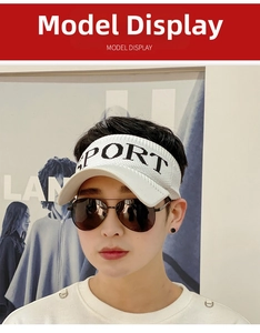 Close-up of a white knitted visor hat for women with black SPORT text for sun protection