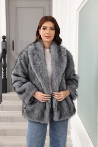 Detail shot of plush grey faux fur coat texture and lapel design on fashion model